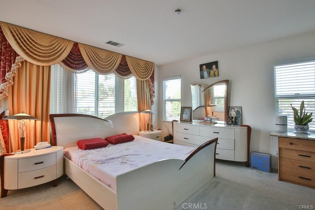 6302 Lavender Way Westminster, CA 92683 - Photo 18 of 38 a bedroom with a bed and a chandelier