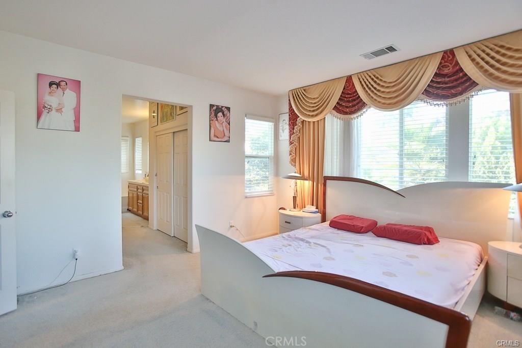 6302 Lavender Way Westminster, CA 92683 - Photo 20 of 38 a bedroom with a bed and a window