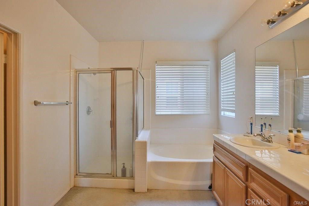 6302 Lavender Way Westminster, CA 92683 - Photo 22 of 38 a bathroom with a granite countertop sink and a bathtub