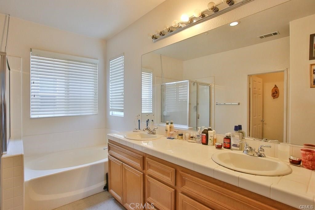 6302 Lavender Way Westminster, CA 92683 - Photo 23 of 38 a bathroom with a double vanity sink and a mirror