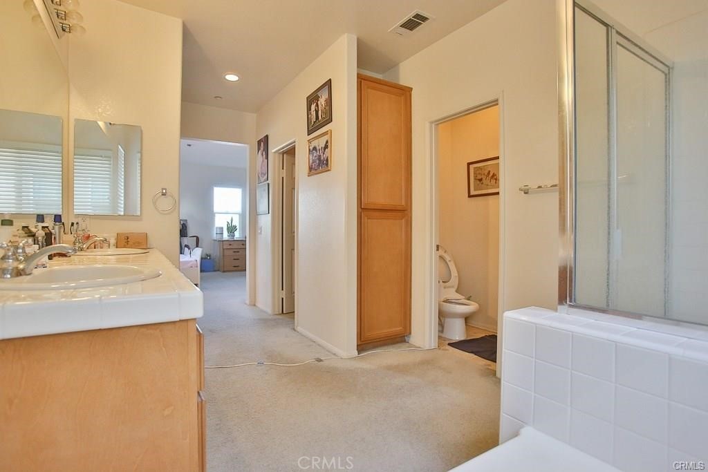 6302 Lavender Way Westminster, CA 92683 - Photo 26 of 38 a spacious bathroom with a granite countertop sink and a mirror