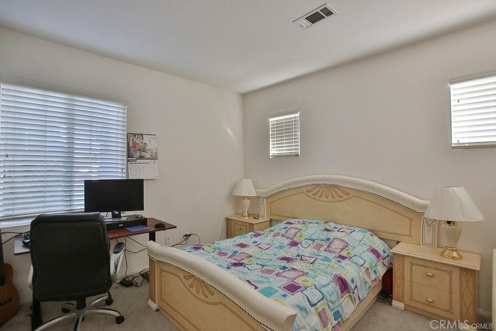 6302 Lavender Way Westminster, CA 92683 - Photo 28 of 38 a bedroom with a bed and a computer on the desk