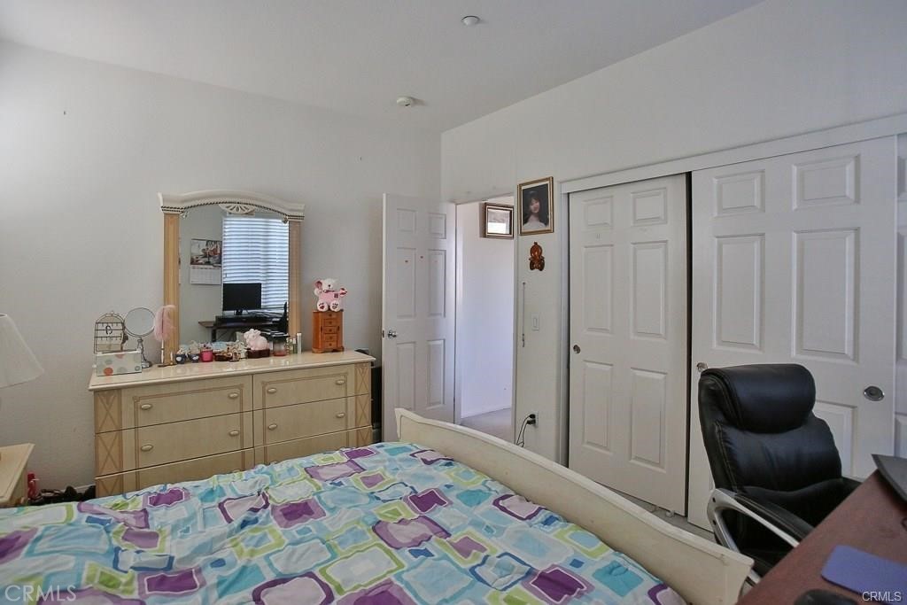 6302 Lavender Way Westminster, CA 92683 - Photo 29 of 38 a room that has a bed and a chair in it