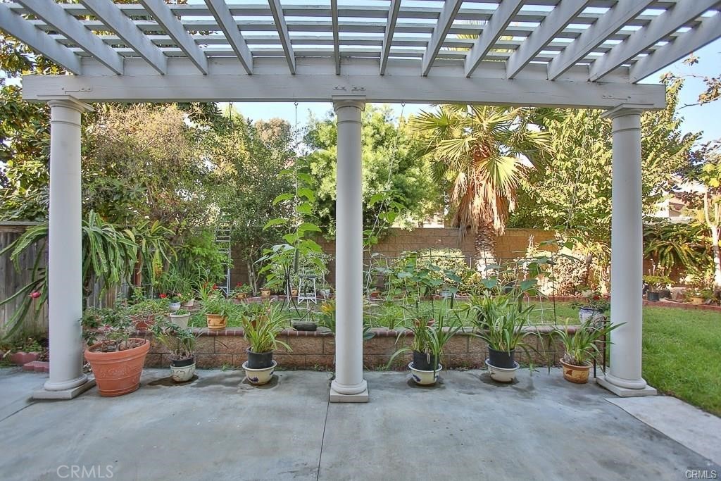 6302 Lavender Way Westminster, CA 92683 - Photo 33 of 38 a view of a patio with table and chairs next to a yard with a garden view