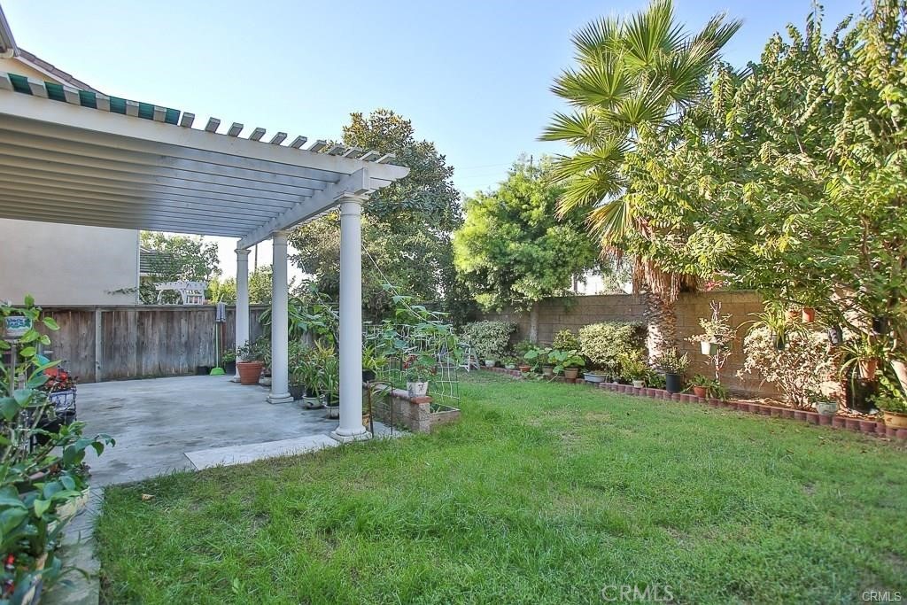 6302 Lavender Way Westminster, CA 92683 - Photo 35 of 38 a view of a patio with a table and chairs under an umbrella