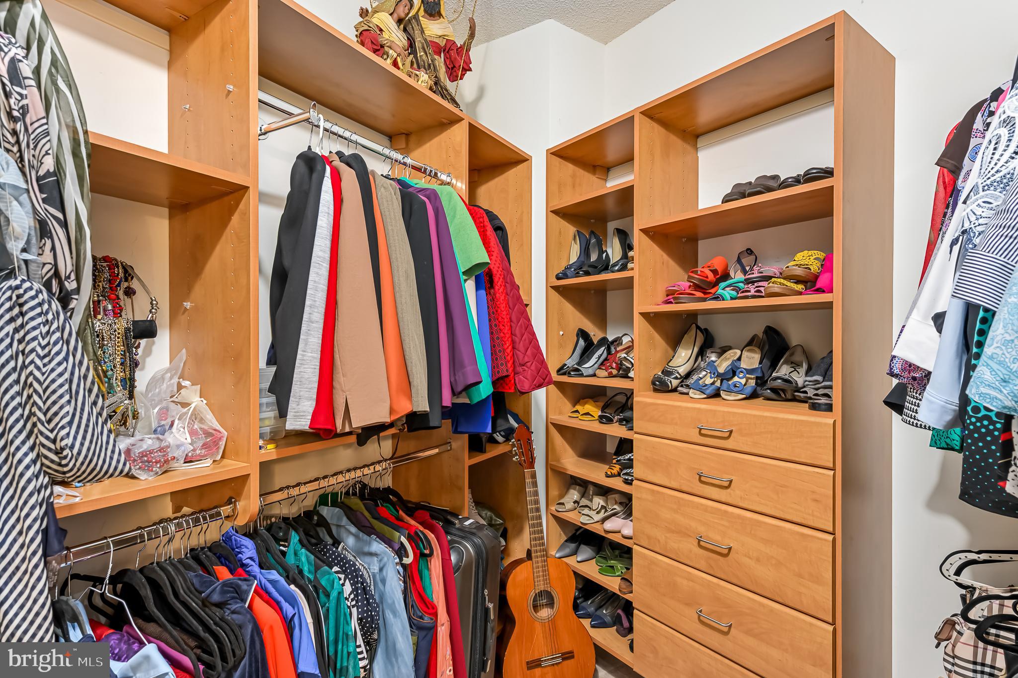 19355 Cypress Ridge Terrace, Unit 1021 Leesburg, VA 20176 - Photo 21 of 51 a view of walk in closet with clothes and shoes