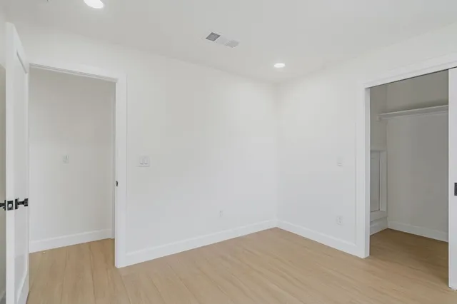 a en suite bathroom with a granite countertop sink and a mirror