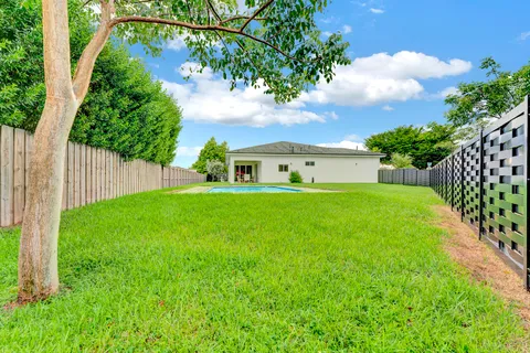 a view of house with backyard