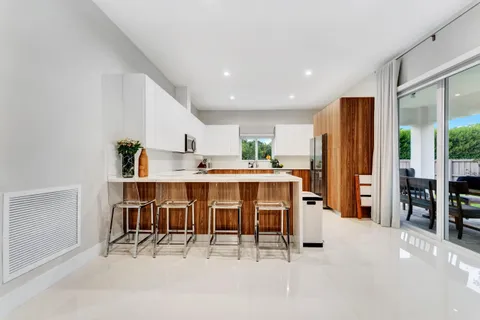 a kitchen with stainless steel appliances kitchen island granite top and refrigerator