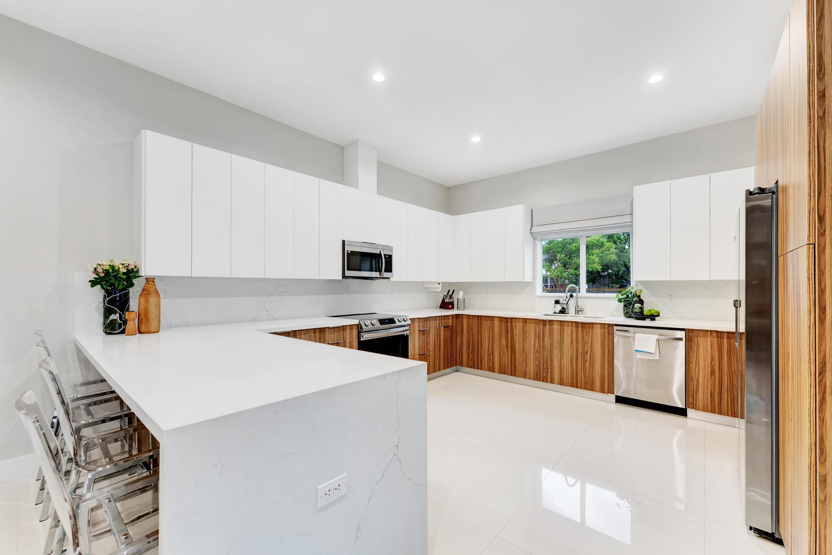 21205 Ingraham Ave Road Cutler Bay, FL 33189 - Photo 20 of 45 a kitchen with stainless steel appliances a refrigerator sink and white cabinets