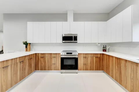 a kitchen with stainless steel appliances a stove a sink and a microwave