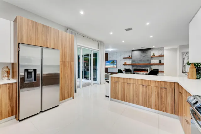 a kitchen with stainless steel appliances a refrigerator and a sink