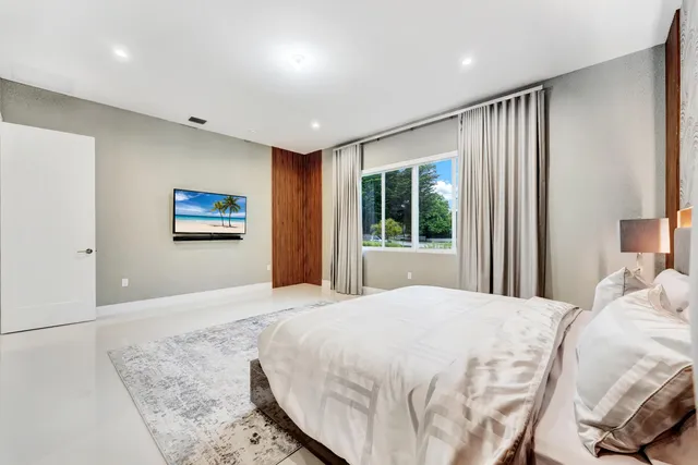 a bedroom with a large bed and a window