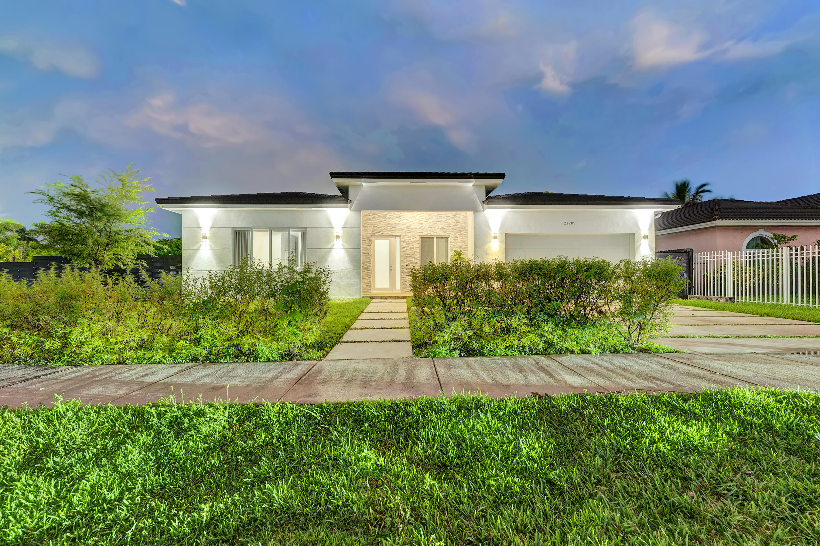 21205 Ingraham Ave Road Cutler Bay, FL 33189 - Photo 3 of 45 a front view of a house with a yard and potted plants