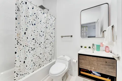 a bathroom with a sink toilet and a mirror