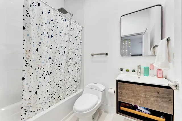 a bathroom with a sink toilet and a mirror