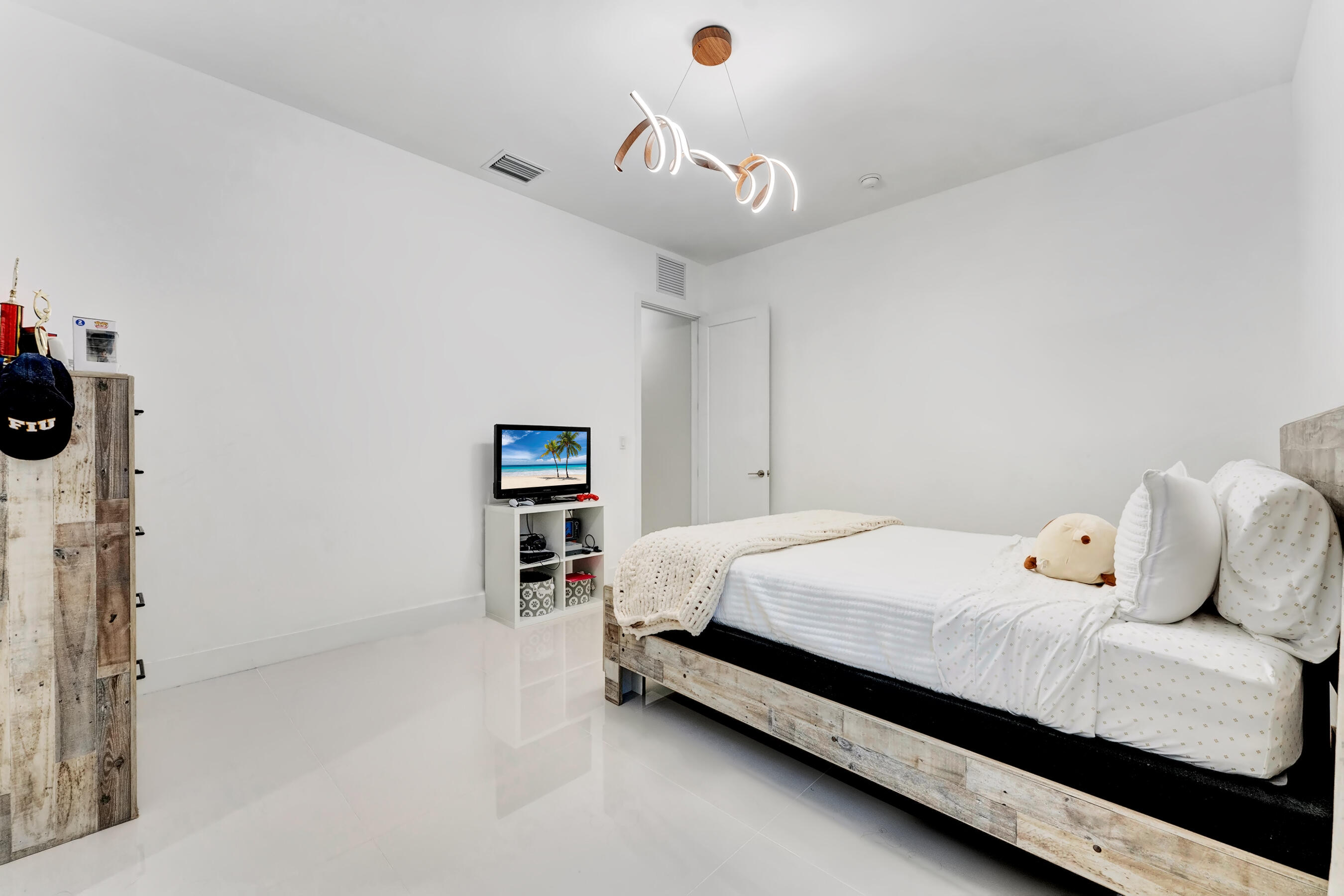 21205 Ingraham Ave Road Cutler Bay, FL 33189 - Photo 33 of 45 a bedroom with a bed and a book shelf