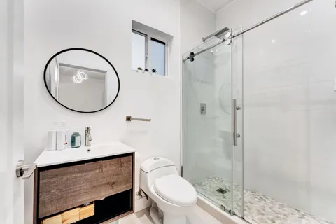 a bathroom with a toilet a sink and a mirror