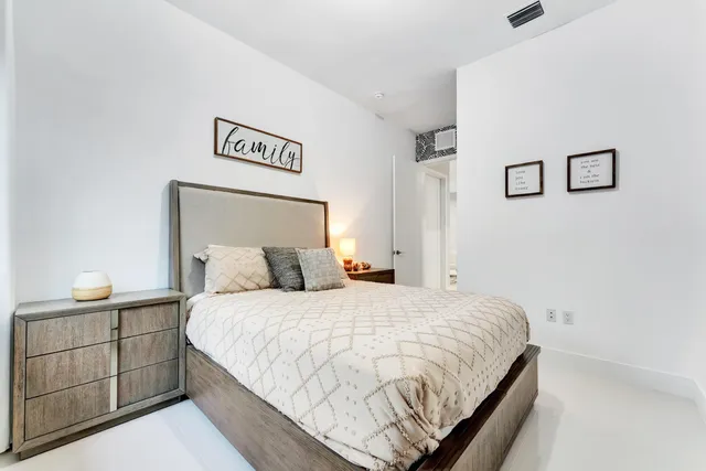 a bedroom with a bed and lamp