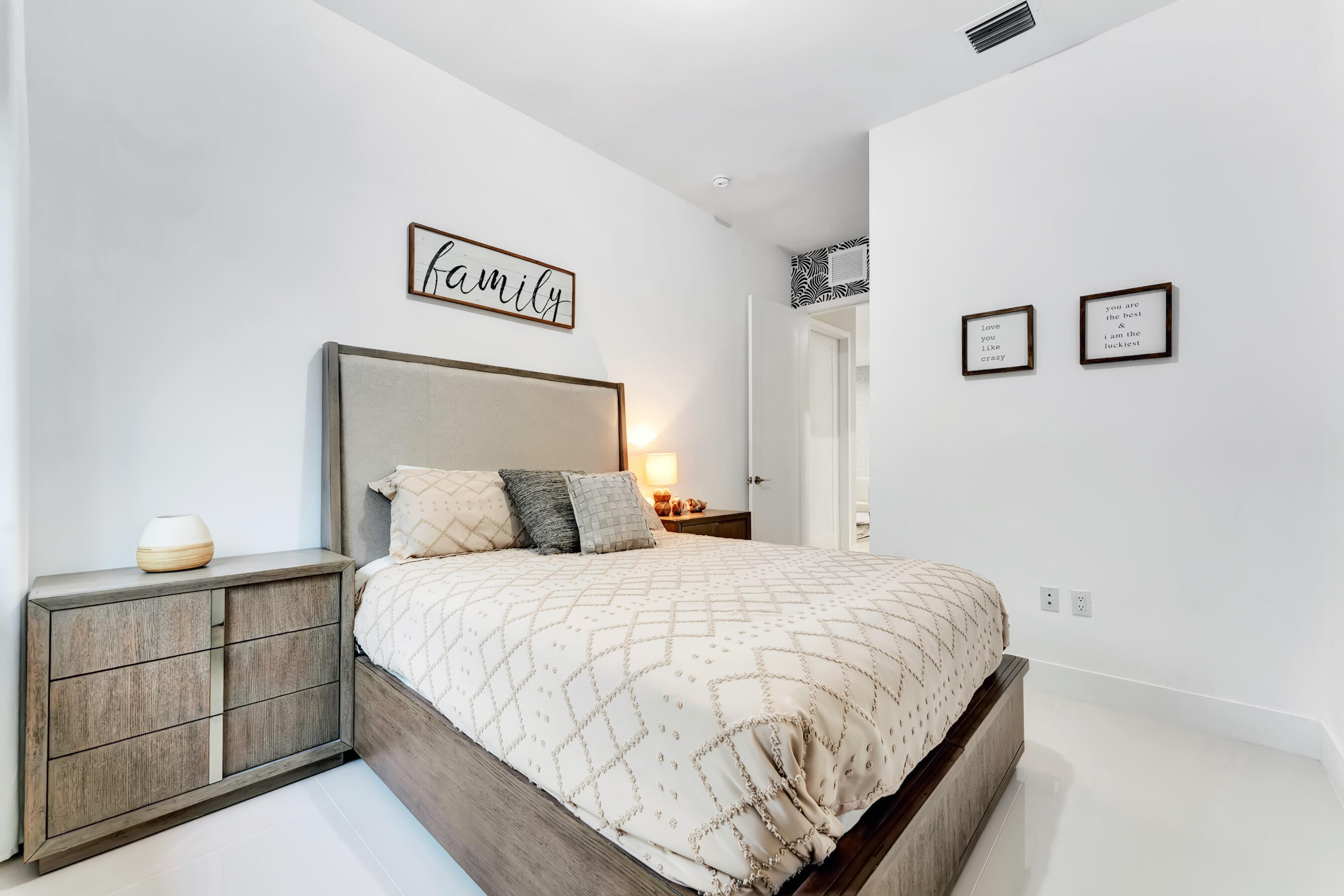 21205 Ingraham Ave Road Cutler Bay, FL 33189 - Photo 35 of 45 a bedroom with a bed and lamp