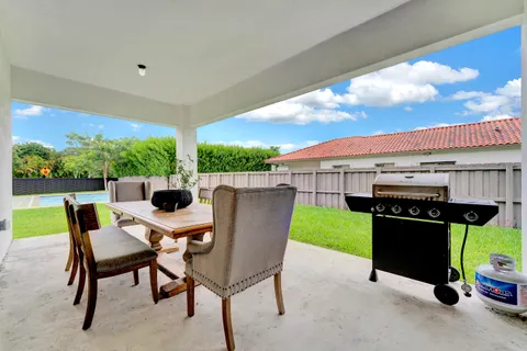 a view of a patio with a table and chairs