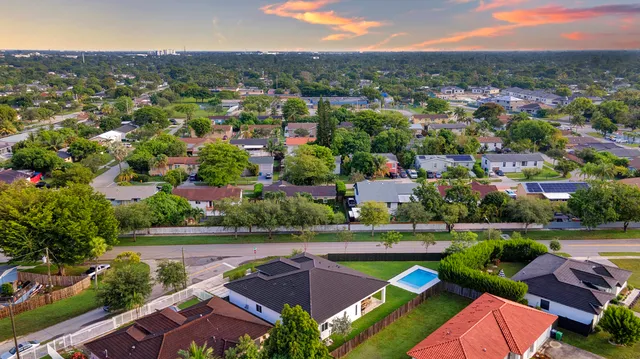 an aerial view of residential houses with outdoor space and river