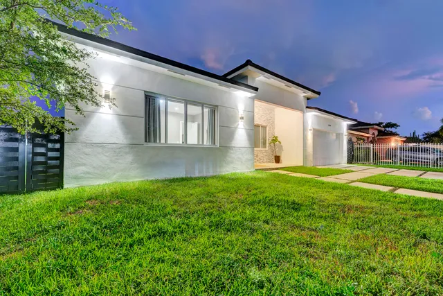 a view of backyard of house with green space