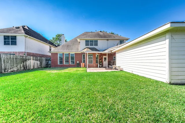 a front view of a house with yard and green space