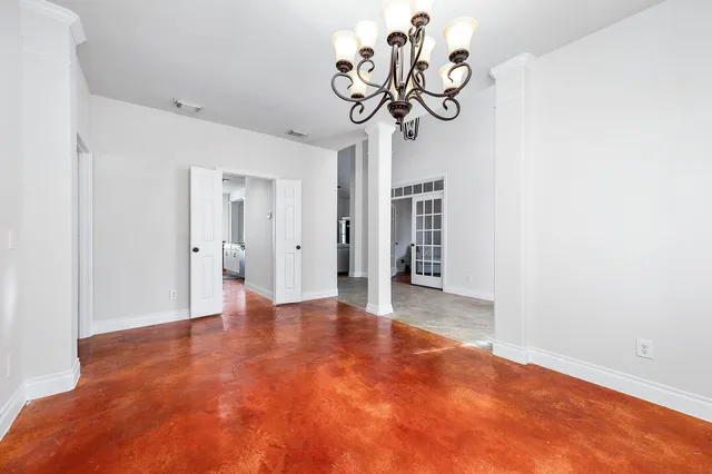 a view of an empty room with a chandelier