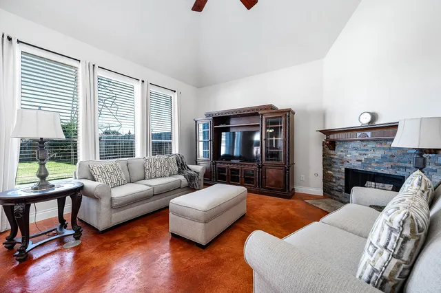 a living room with furniture and a fireplace