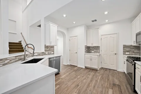 a kitchen with a sink stove and refrigerator