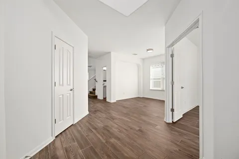 a view of a hallway with wooden floor