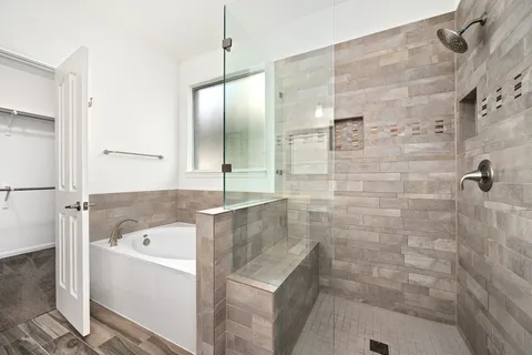 a bathroom with a bathtub and a shower
