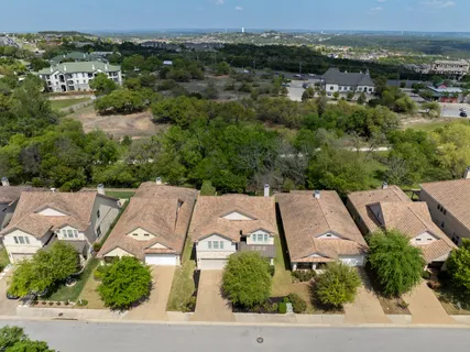 an aerial view of residential houses with outdoor space