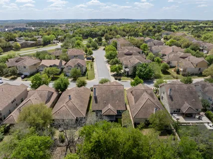 an aerial view of residential houses with outdoor space