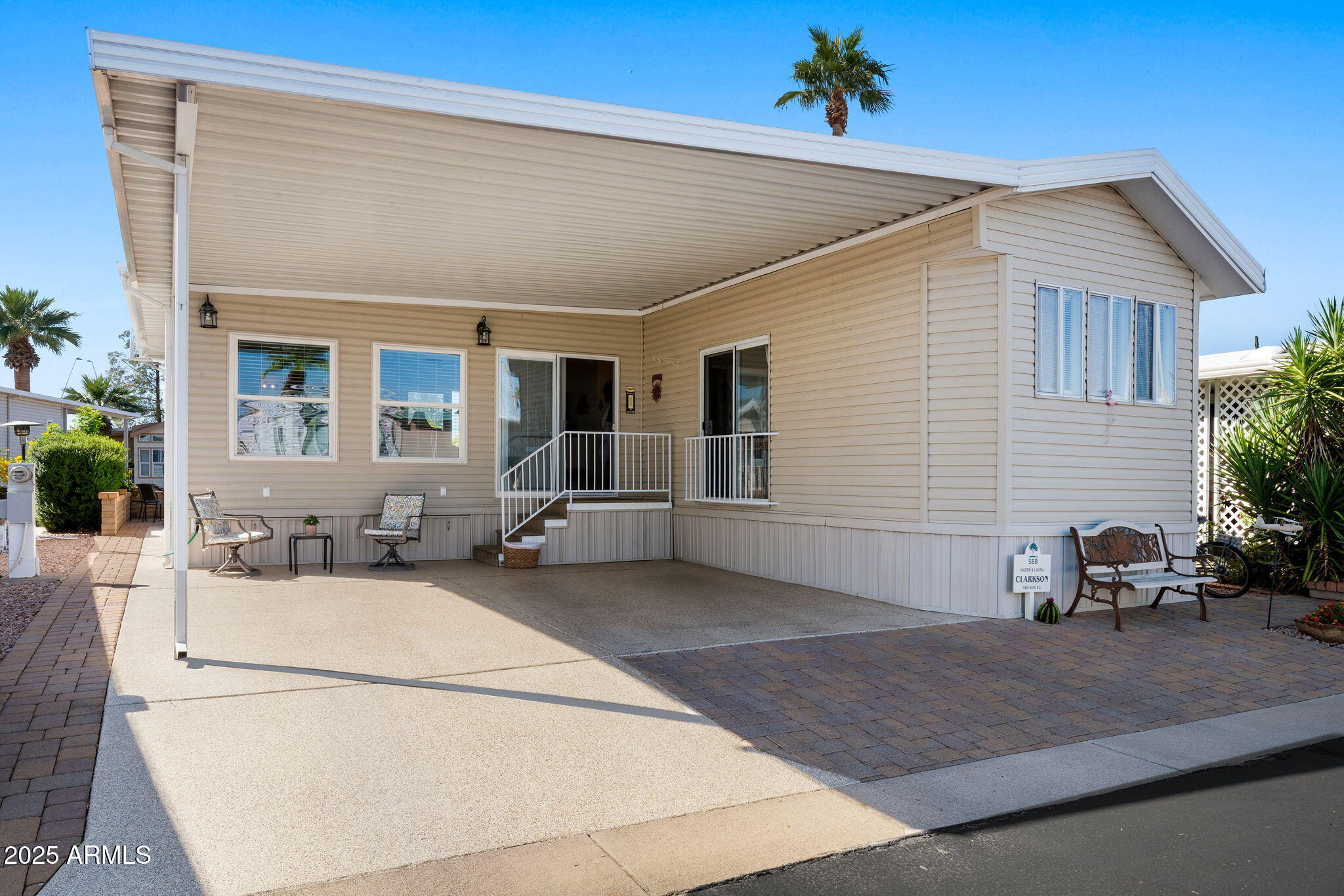 111 South Greenfield Road, Unit 588 Mesa, AZ 85206 - Photo 1 of 16 a view of a white house with a patio