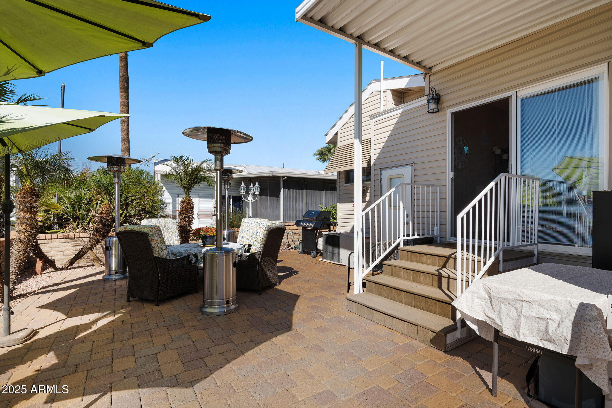 111 South Greenfield Road, Unit 588 Mesa, AZ 85206 - Photo 16 of 16 a view of a patio with a table and chairs under an umbrella