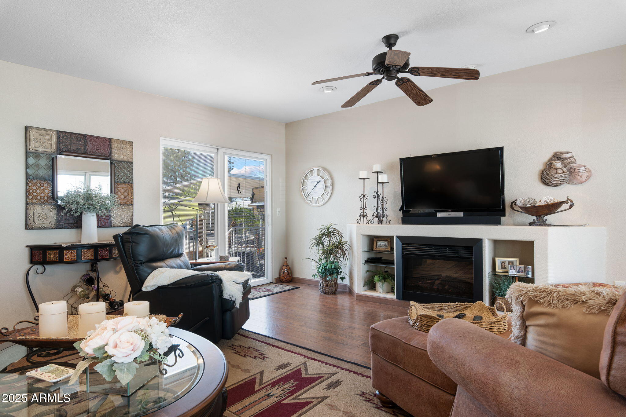 111 South Greenfield Road, Unit 588 Mesa, AZ 85206 - Photo 3 of 16 a living room with furniture a flat screen tv and a fireplace