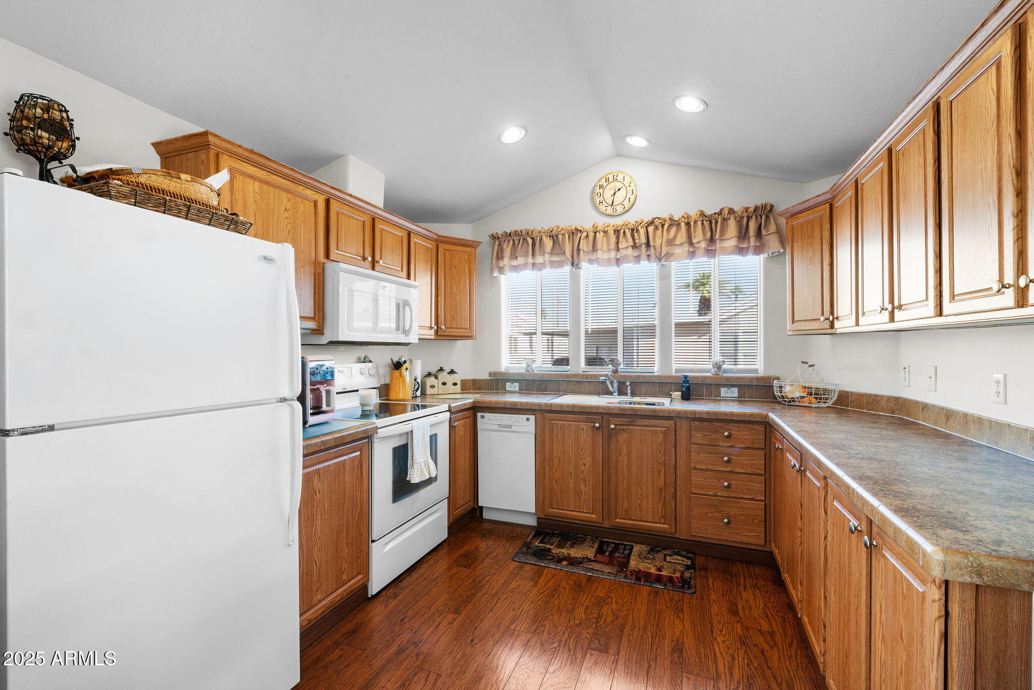 111 South Greenfield Road, Unit 588 Mesa, AZ 85206 - Photo 6 of 16 a kitchen with a sink a refrigerator and wooden floor