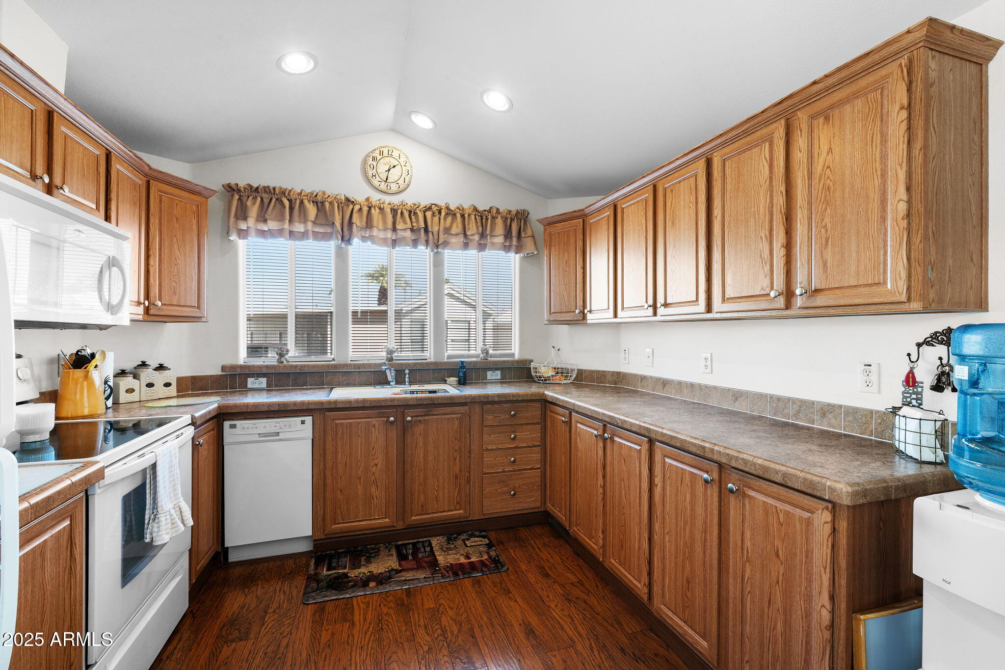 111 South Greenfield Road, Unit 588 Mesa, AZ 85206 - Photo 7 of 16 a kitchen with stainless steel appliances granite countertop a sink and wooden cabinets