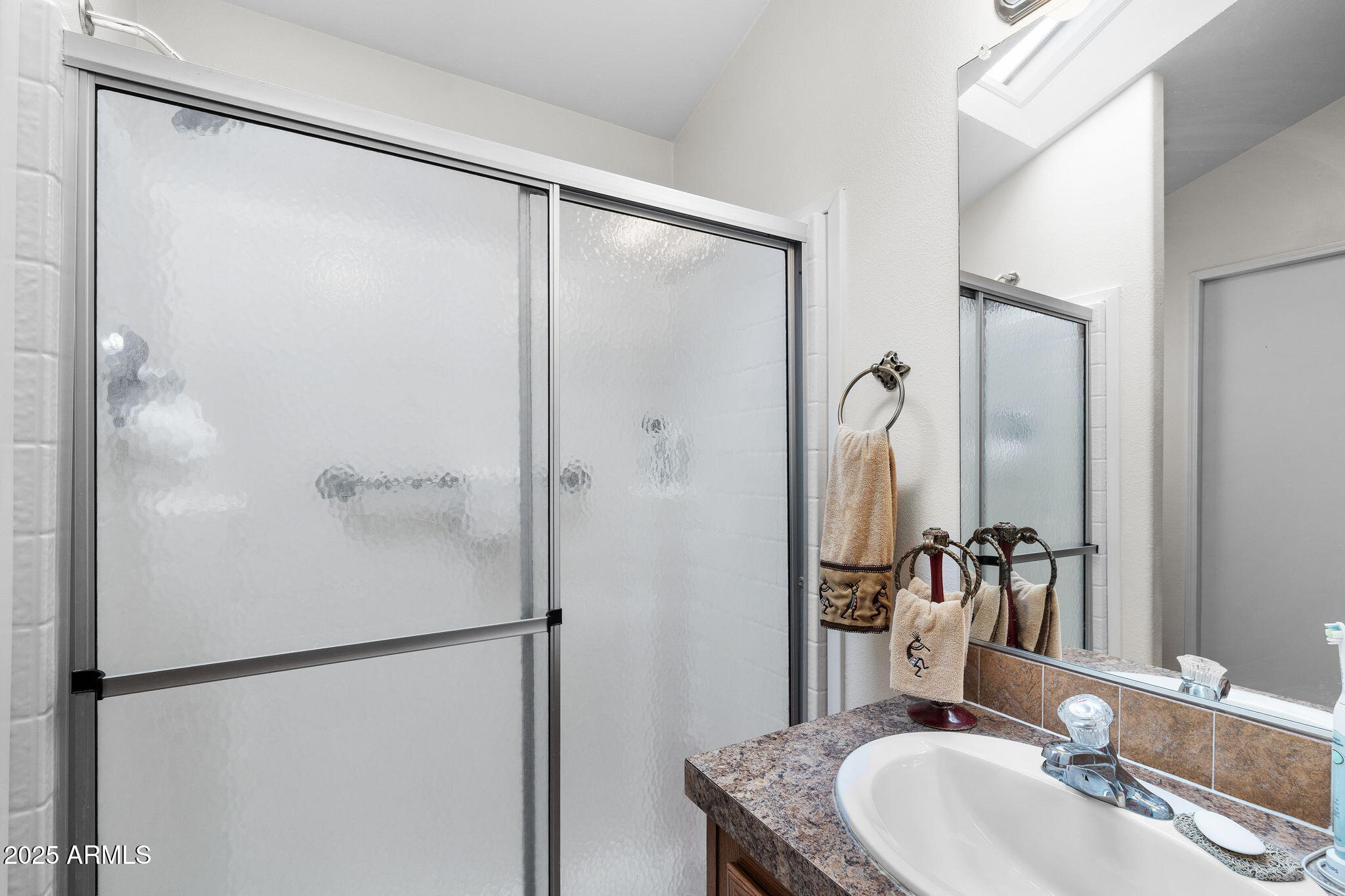 111 South Greenfield Road, Unit 588 Mesa, AZ 85206 - Photo 10 of 16 a bathroom with a sink and a mirror