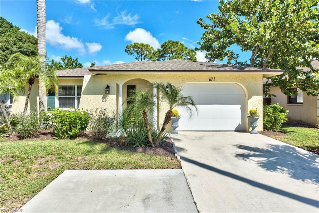 671 98th Avenue North Naples, FL 34108 - Photo 1 of 27 front view of house with a garden