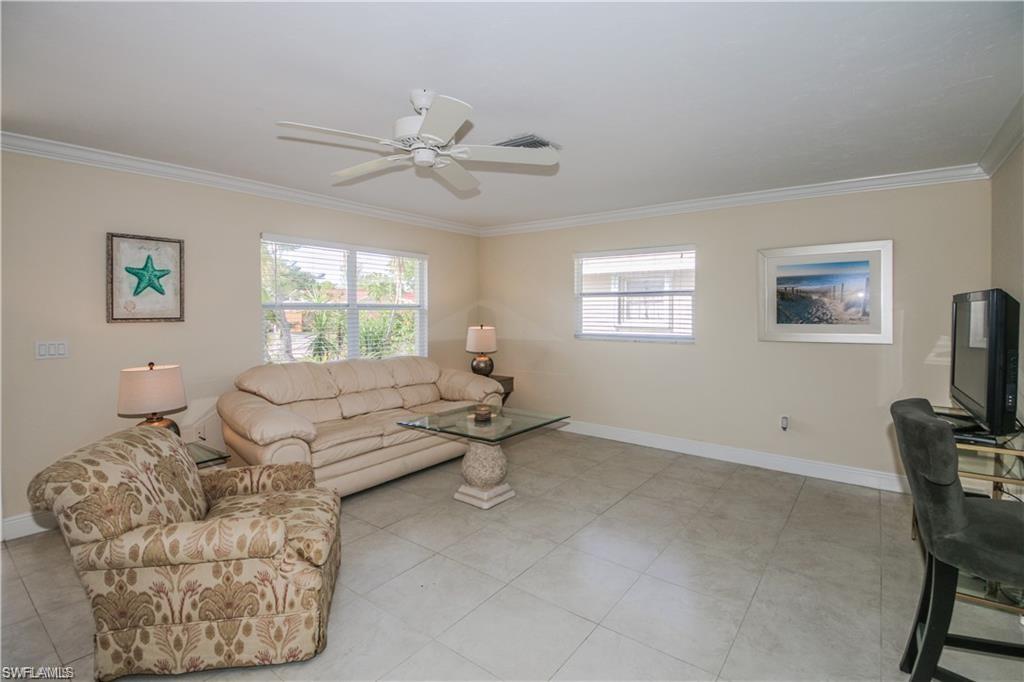 671 98th Avenue North Naples, FL 34108 - Photo 10 of 27 a living room with furniture and a window