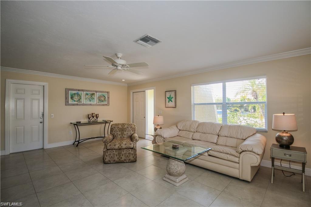 671 98th Avenue North Naples, FL 34108 - Photo 11 of 27 a living room with furniture and a large window
