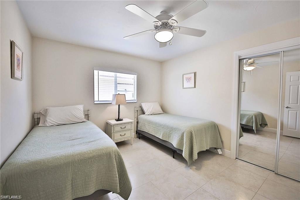 671 98th Avenue North Naples, FL 34108 - Photo 17 of 27 a bedroom with two beds and window
