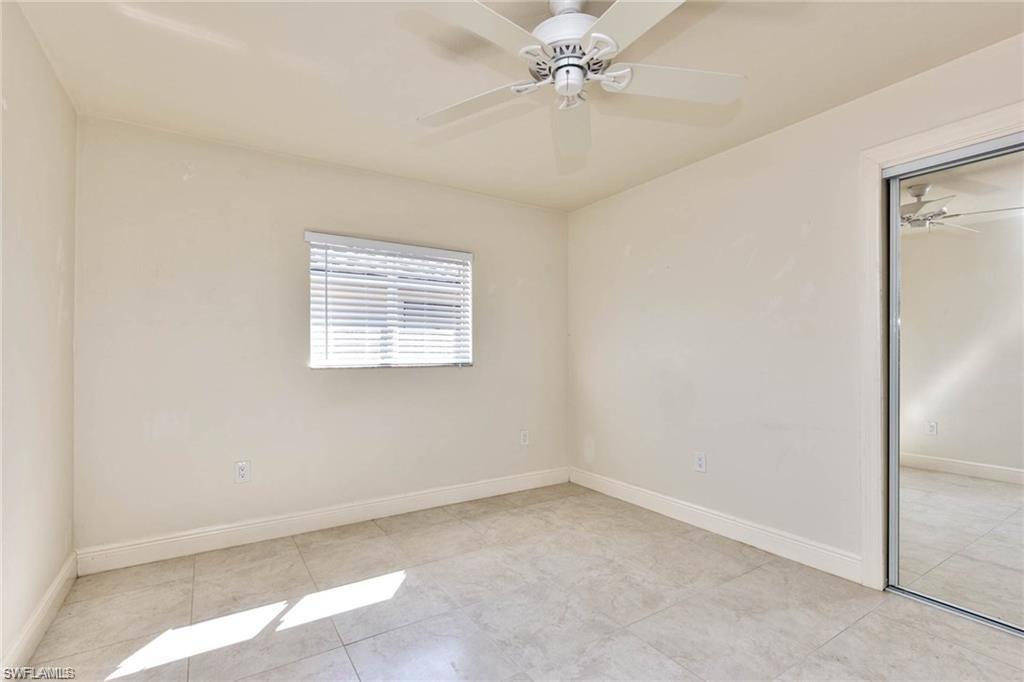 671 98th Avenue North Naples, FL 34108 - Photo 18 of 27 an empty room with a window and a fan