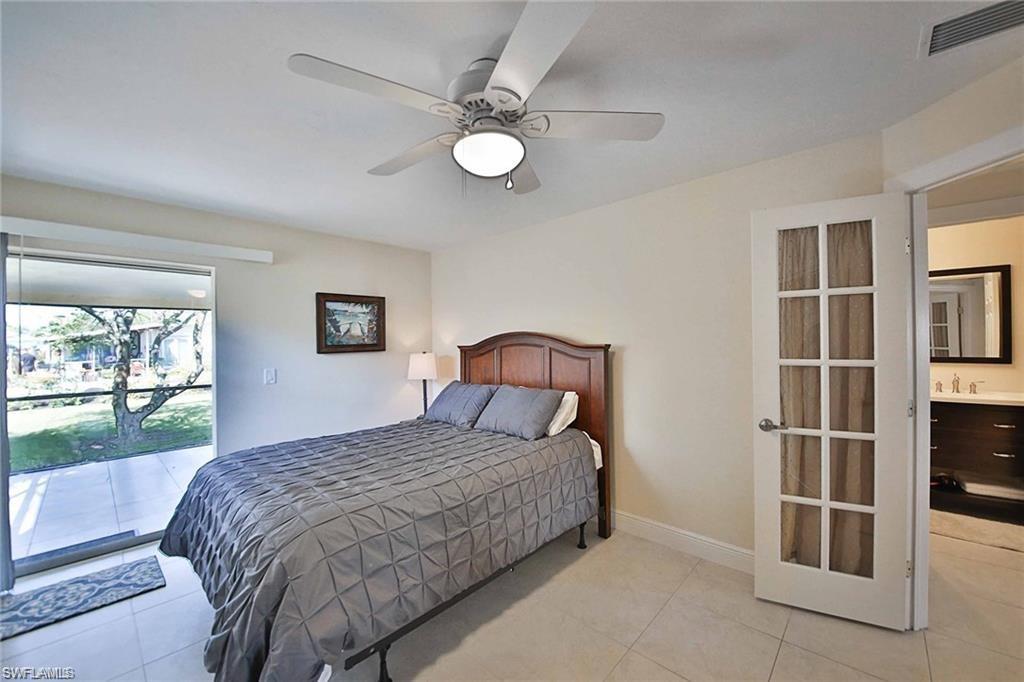 671 98th Avenue North Naples, FL 34108 - Photo 20 of 27 a bedroom with a bed and a window