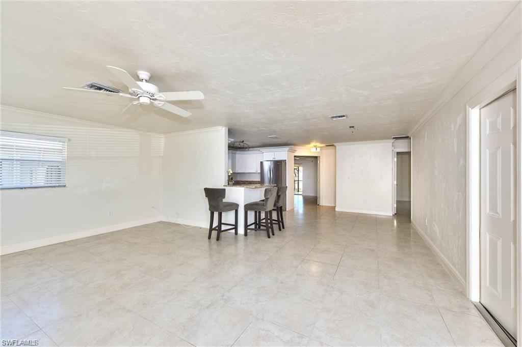 671 98th Avenue North Naples, FL 34108 - Photo 4 of 27 a view of a livingroom with furniture and a ceiling fan