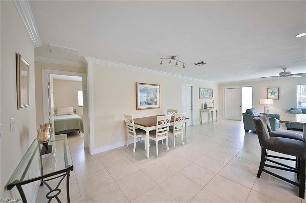 671 98th Avenue North Naples, FL 34108 - Photo 8 of 27 a dining room with furniture and wooden floor