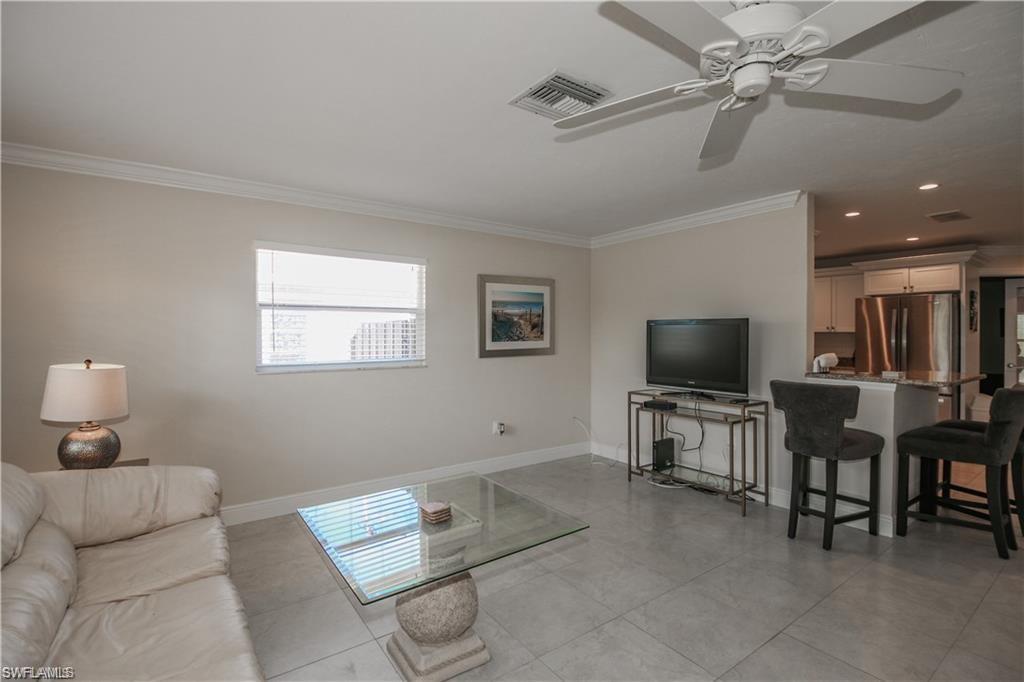 671 98th Avenue North Naples, FL 34108 - Photo 9 of 27 a living room with furniture and a flat screen tv